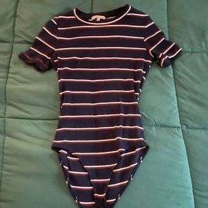 Cute bodysuit, size small but can fit a medium. Charlotte Ruse brand.